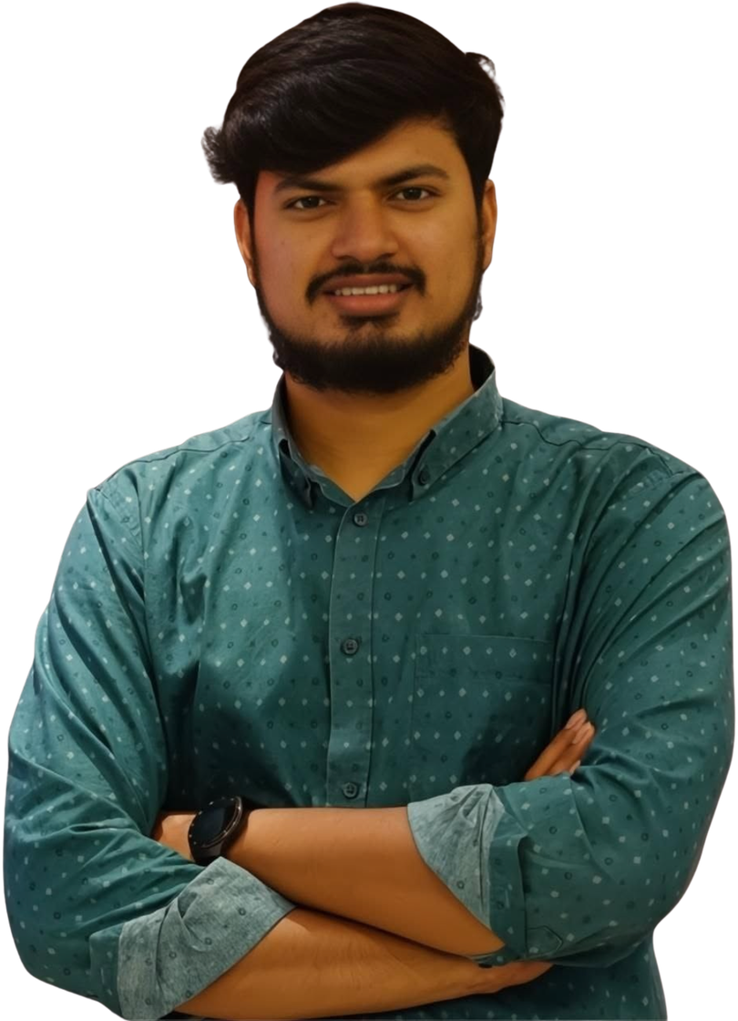 Portrait of Shalman Shah, smiling with arms crossed, wearing a teal patterned shirt